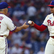 Pitcher Mauricio Llovera of the Philadelphia Phillies hands the ball to manager Joe Girardi after surrendering three consecutive home runs during the ninth inning of a game against the New York Mets